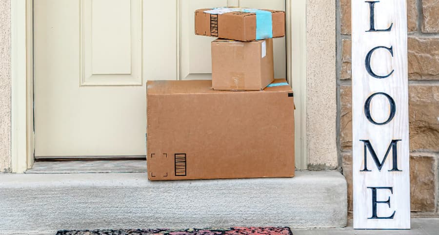 Boxes by the door of a residence with a welcome sign in Dayton